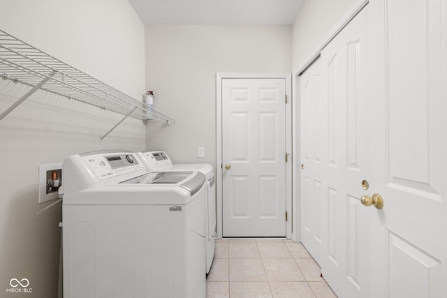 13019 Pinner Ave, Fishers, IN 46037 - laundry area featuring independent washer and dryer and light tile patterned floors