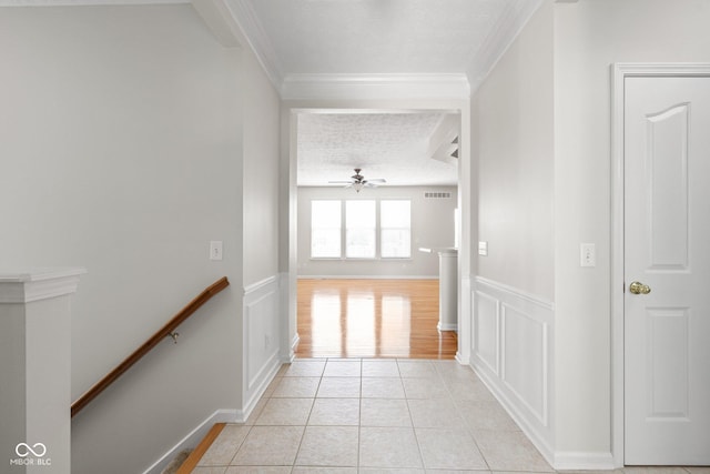 13019 Pinner Ave, Fishers, IN 46037 - corridor with ornamental molding, a wainscoted wall, an upstairs landing, light tile patterned floors, and a textured ceiling