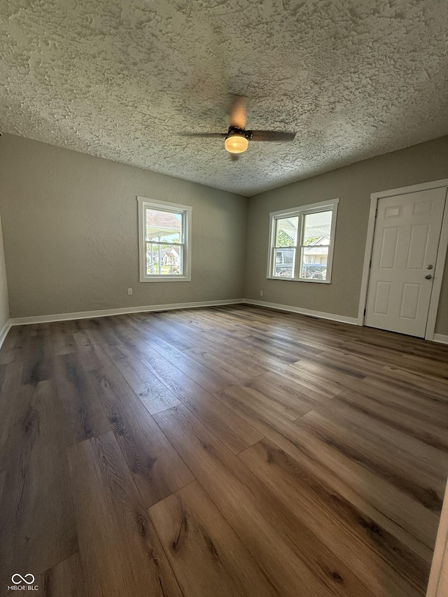 131 S Beatty St, Columbus, IN 47201 - spare room with a textured ceiling, dark wood-type flooring, and a ceiling fan