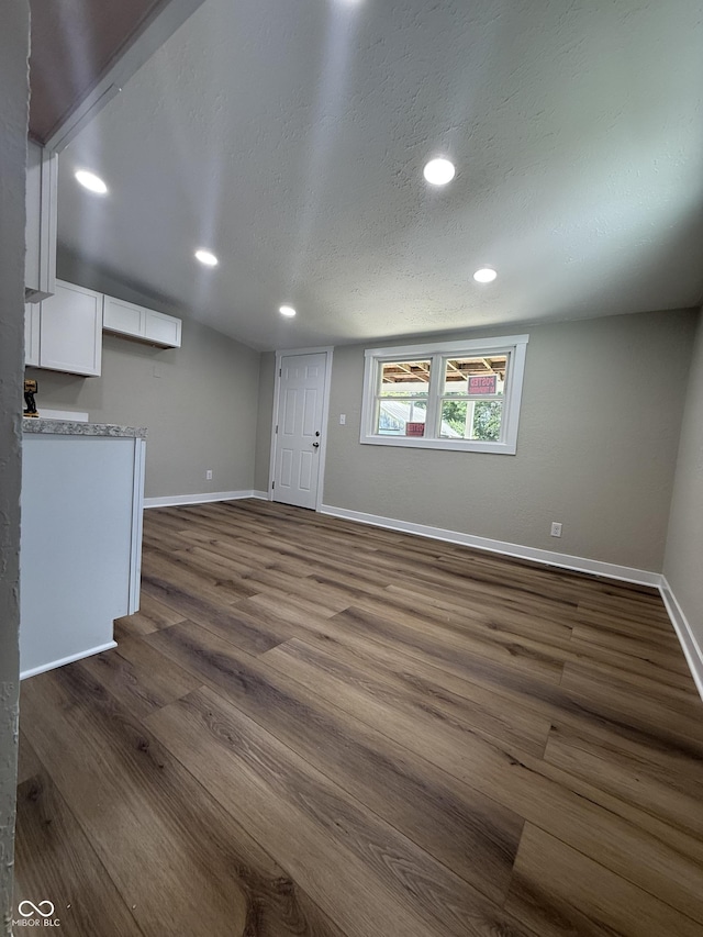 131 S Beatty St, Columbus, IN 47201 - unfurnished living room with dark wood-style floors, recessed lighting, and a textured ceiling