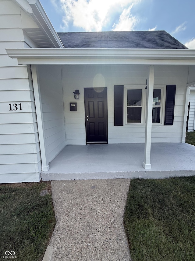 131 S Beatty St, Columbus, IN 47201 - view of exterior entry featuring covered porch and a shingled roof