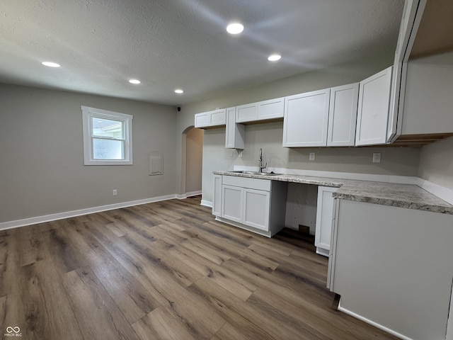 131 S Beatty St, Columbus, IN 47201 - kitchen featuring arched walkways, recessed lighting, white cabinets, dark wood-style flooring, and a textured ceiling