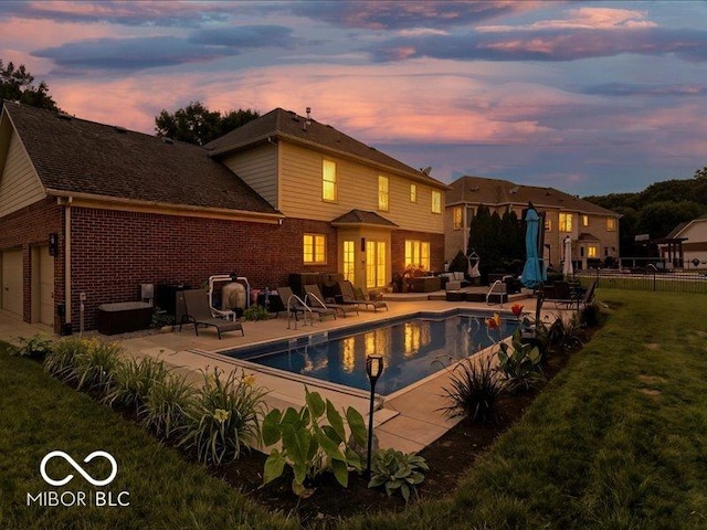 4233 Dartmoor Dr, Greenwood, IN 46143 - rear view of house featuring brick siding, a patio area, and an outdoor living space