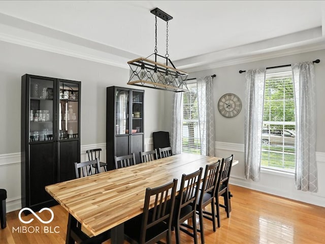 4233 Dartmoor Dr, Greenwood, IN 46143 - dining area featuring light wood-style floors, a wainscoted wall, and crown molding