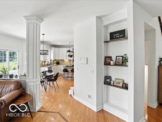 4233 Dartmoor Dr, Greenwood, IN 46143 - hall with light wood-style floors, ornate columns, and recessed lighting