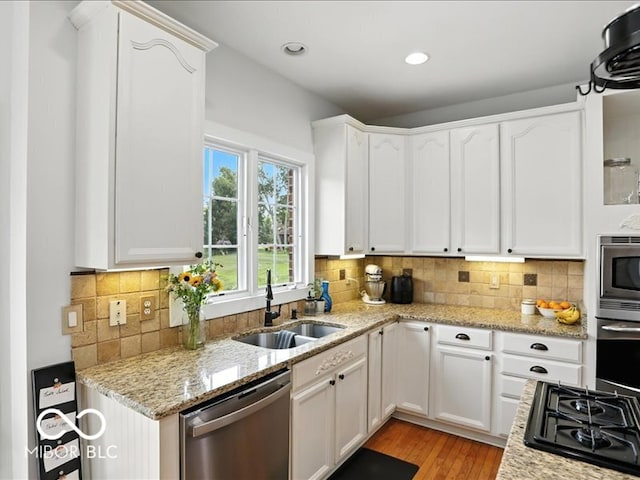 4233 Dartmoor Dr, Greenwood, IN 46143 - kitchen featuring stainless steel appliances, white cabinetry, and recessed lighting