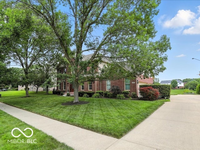 4233 Dartmoor Dr, Greenwood, IN 46143 - obstructed view of property with a front yard and brick siding