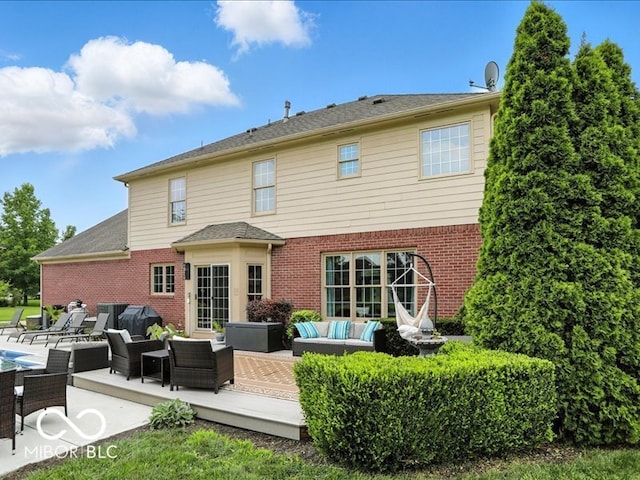 4233 Dartmoor Dr, Greenwood, IN 46143 - rear view of property featuring an outdoor living space, brick siding, a pool, and a patio