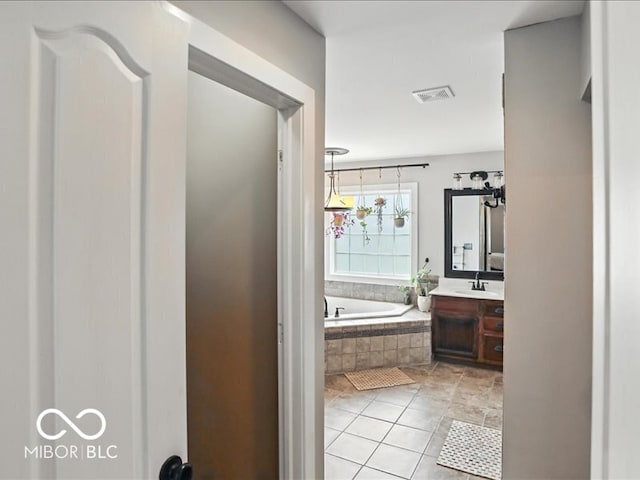 4233 Dartmoor Dr, Greenwood, IN 46143 - bathroom featuring vanity, a garden tub, and tile patterned flooring
