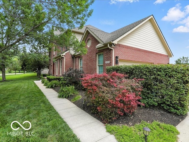 4233 Dartmoor Dr, Greenwood, IN 46143 - view of side of property with brick siding, a yard, and a shingled roof