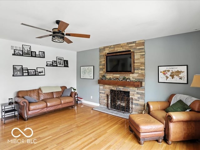 4233 Dartmoor Dr, Greenwood, IN 46143 - living area featuring wood finished floors, a fireplace, and a ceiling fan