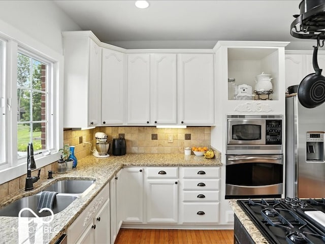 4233 Dartmoor Dr, Greenwood, IN 46143 - kitchen with stainless steel appliances, white cabinetry, light wood finished floors, and recessed lighting