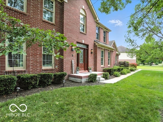 4233 Dartmoor Dr, Greenwood, IN 46143 - view of front of home featuring a front yard and brick siding