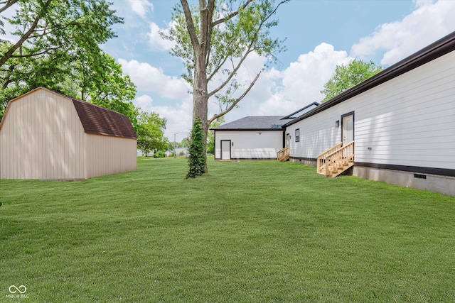 2125 N Pasadena St, Indianapolis, IN 46219 - view of grassy yard featuring entry steps and a storage shed
