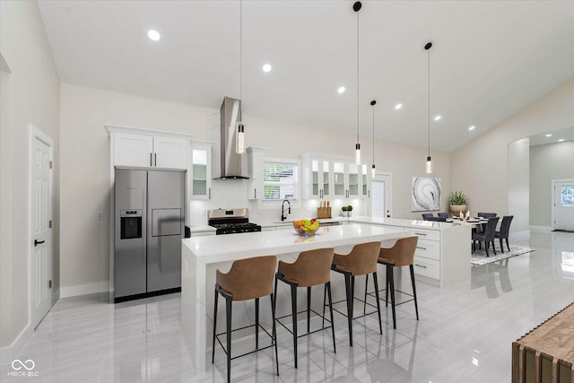 2125 N Pasadena St, Indianapolis, IN 46219 - kitchen featuring stainless steel appliances, wall chimney range hood, a peninsula, a kitchen island, and a kitchen bar