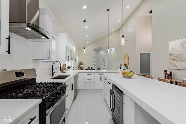 2125 N Pasadena St, Indianapolis, IN 46219 - kitchen with appliances with stainless steel finishes, wall chimney exhaust hood, wine cooler, light stone countertops, and high vaulted ceiling