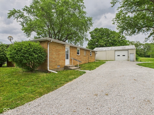203 Plum St E, Frankton, IN 46044 - view of property exterior with brick siding, driveway, an outdoor structure, a garage, and a lawn