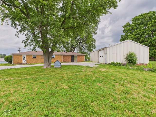203 Plum St E, Frankton, IN 46044 - view of green lawn with an outbuilding and a garage