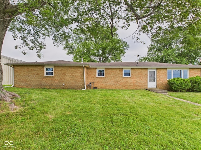 203 Plum St E, Frankton, IN 46044 - rear view of property featuring brick siding and a lawn