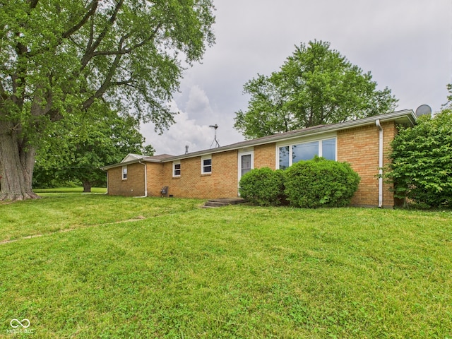 203 Plum St E, Frankton, IN 46044 - back of property with brick siding and a yard