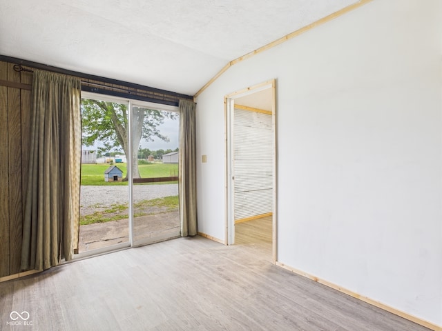 203 Plum St E, Frankton, IN 46044 - unfurnished room with wood finished floors and vaulted ceiling