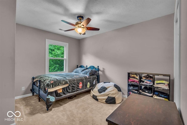 7502 Colony Cir, Indianapolis, IN 46260 - bedroom with carpet flooring, a ceiling fan, and a textured ceiling