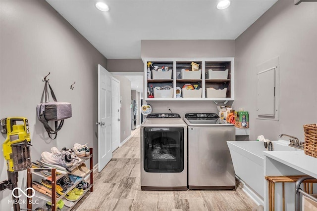 7502 Colony Cir, Indianapolis, IN 46260 - washroom with light wood-style flooring, washing machine and dryer, and recessed lighting