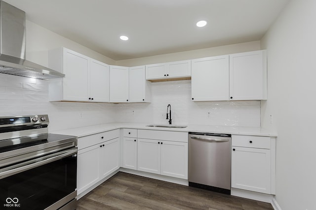 5134 Rinehart Ave, Indianapolis, IN 46241 - kitchen featuring appliances with stainless steel finishes, wall chimney exhaust hood, light countertops, white cabinetry, and recessed lighting