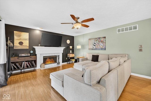 13470 Shakamac Dr, Carmel, IN 46032 - living room with a ceiling fan, wood finished floors, and a tile fireplace
