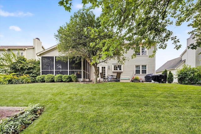 13470 Shakamac Dr, Carmel, IN 46032 - back of house featuring a sunroom, a lawn, and a patio area