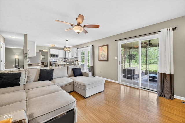13470 Shakamac Dr, Carmel, IN 46032 - living area with ceiling fan and light wood-style flooring