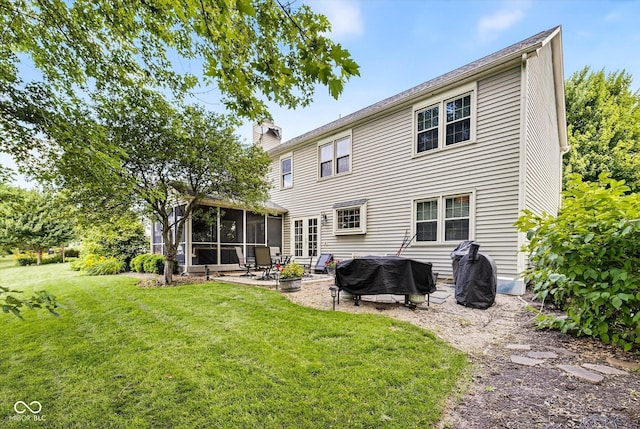 13470 Shakamac Dr, Carmel, IN 46032 - rear view of house with a sunroom, a chimney, a lawn, an outdoor fire pit, and a patio
