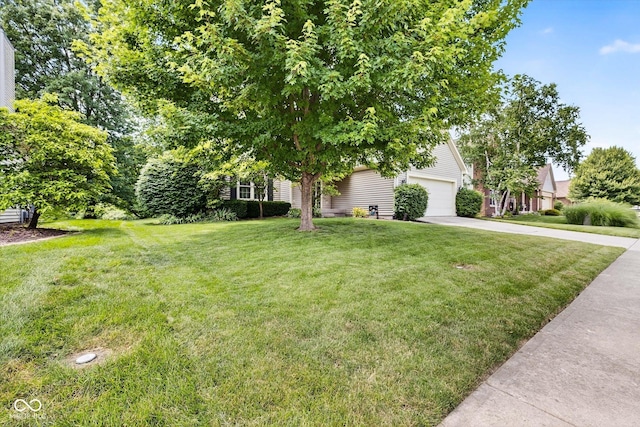 13470 Shakamac Dr, Carmel, IN 46032 - view of green lawn with concrete driveway and an attached garage
