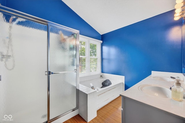 13470 Shakamac Dr, Carmel, IN 46032 - full bath featuring vaulted ceiling, a shower stall, a bath, wood finished floors, and double vanity