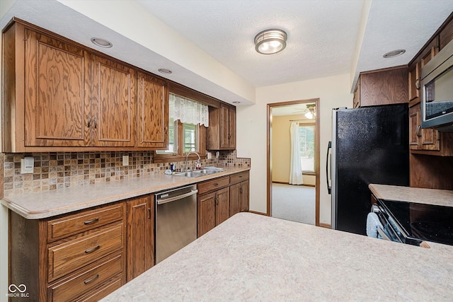 450 W 250 N, Lebanon, IN 46052 - kitchen with stainless steel appliances, light countertops, tasteful backsplash, brown cabinets, and a ceiling fan