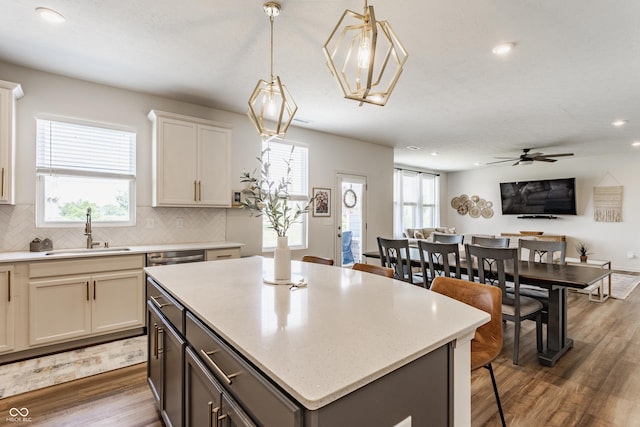 6902 Diamondleaf Way, Brownsburg, IN 46112 - kitchen featuring wood finished floors, recessed lighting, a center island, backsplash, and pendant lighting