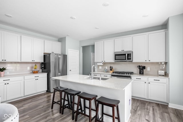 3969 Canning St, Danville, IN 46122 - kitchen featuring stainless steel appliances, backsplash, light wood-style floors, white cabinetry, and recessed lighting