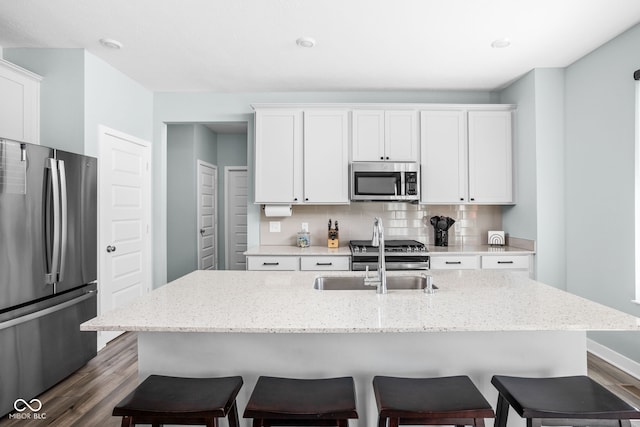 3969 Canning St, Danville, IN 46122 - kitchen featuring stainless steel appliances, dark wood-type flooring, a breakfast bar area, and white cabinetry