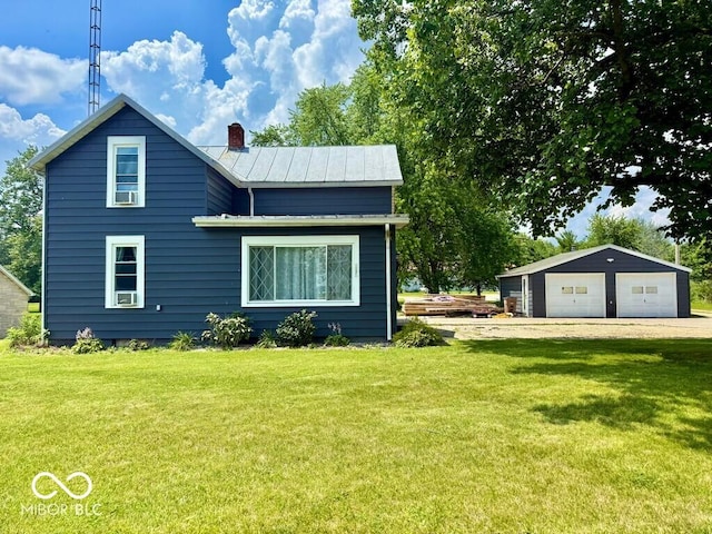 1076 N Old Highway 27, Winchester, IN 47394 - view of front of house with a garage, a front lawn, a chimney, and a metal roof