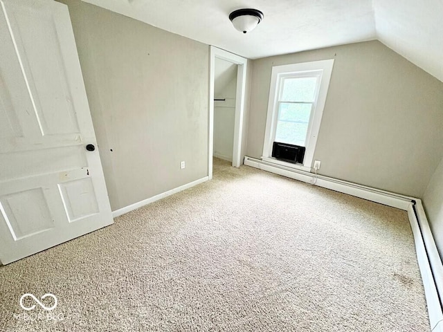 1076 N Old Highway 27, Winchester, IN 47394 - unfurnished bedroom featuring carpet floors, a closet, vaulted ceiling, and a baseboard heating unit