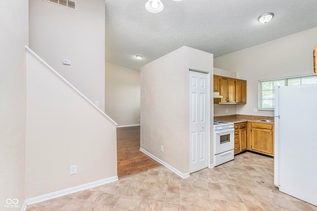 3515 Bearwood Ct, Indianapolis, IN 46235 - kitchen featuring white appliances, brown cabinets, and under cabinet range hood