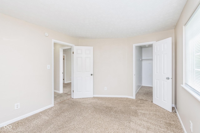 3515 Bearwood Ct, Indianapolis, IN 46235 - unfurnished bedroom featuring light carpet, a spacious closet, and a closet