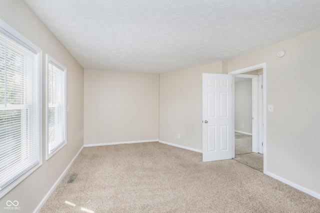 3515 Bearwood Ct, Indianapolis, IN 46235 - carpeted spare room featuring a textured ceiling and a smoke detector