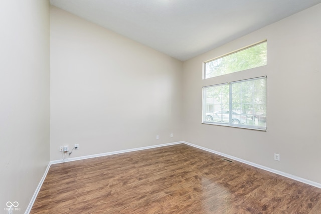 3515 Bearwood Ct, Indianapolis, IN 46235 - spare room with dark wood-type flooring and lofted ceiling