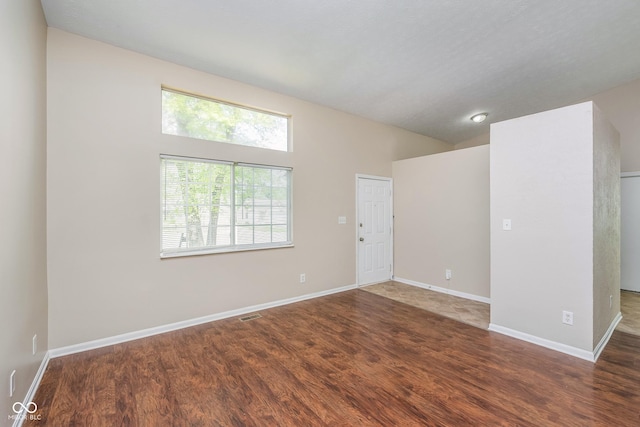 3515 Bearwood Ct, Indianapolis, IN 46235 - empty room with wood finished floors and vaulted ceiling