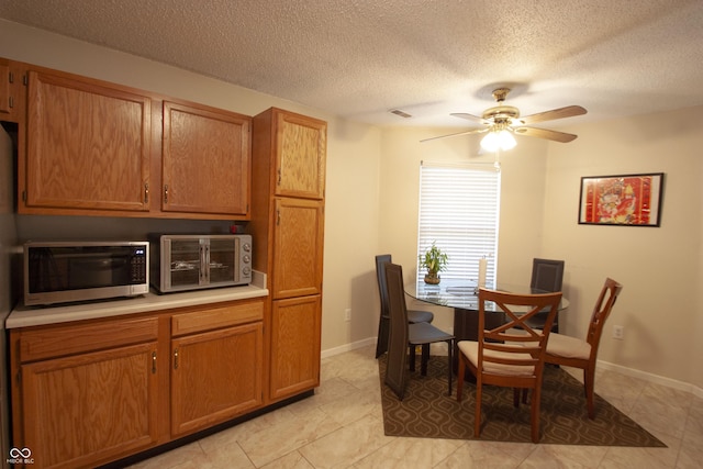 291 Lakemoore St, Brownsburg, IN 46112 - dining room with ceiling fan, a textured ceiling, and light tile patterned floors