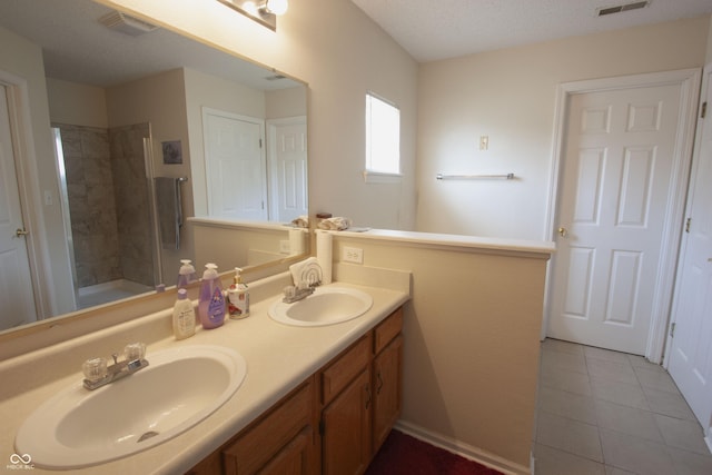 291 Lakemoore St, Brownsburg, IN 46112 - bathroom featuring double vanity, a tile shower, and tile patterned floors
