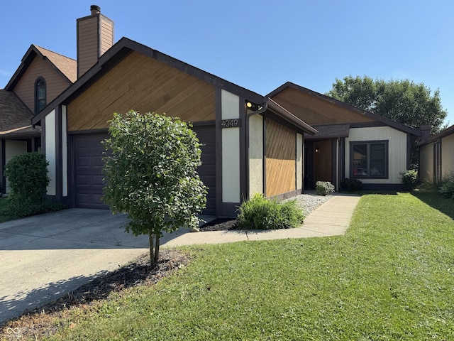 4049 Zinfandel Way, Indianapolis, IN 46254 - view of front of property with an attached garage, a chimney, a front yard, and driveway
