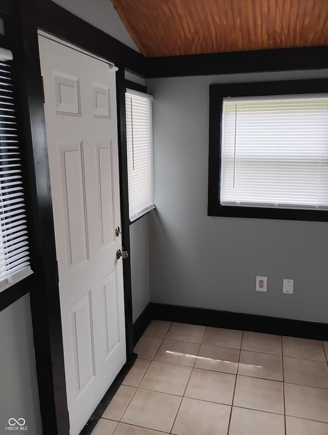94 N Routiers Ave, Indianapolis, IN 46219 - unfurnished room featuring light tile patterned floors and vaulted ceiling