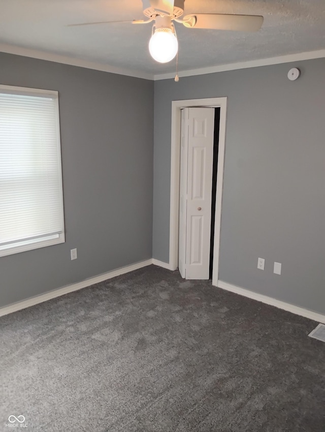 94 N Routiers Ave, Indianapolis, IN 46219 - spare room featuring a ceiling fan, dark carpet, and a smoke detector